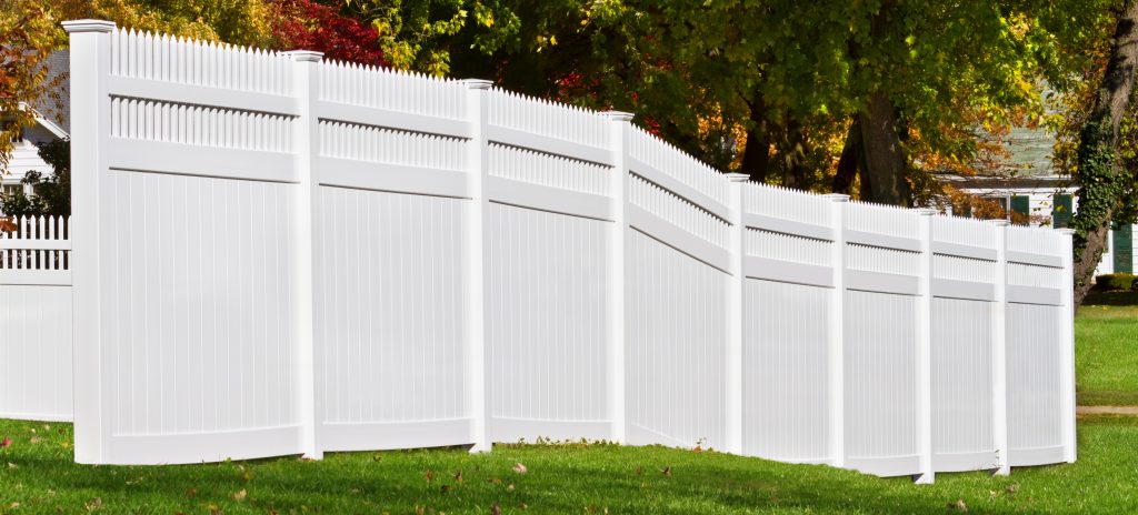 New white vinyl fence in yard